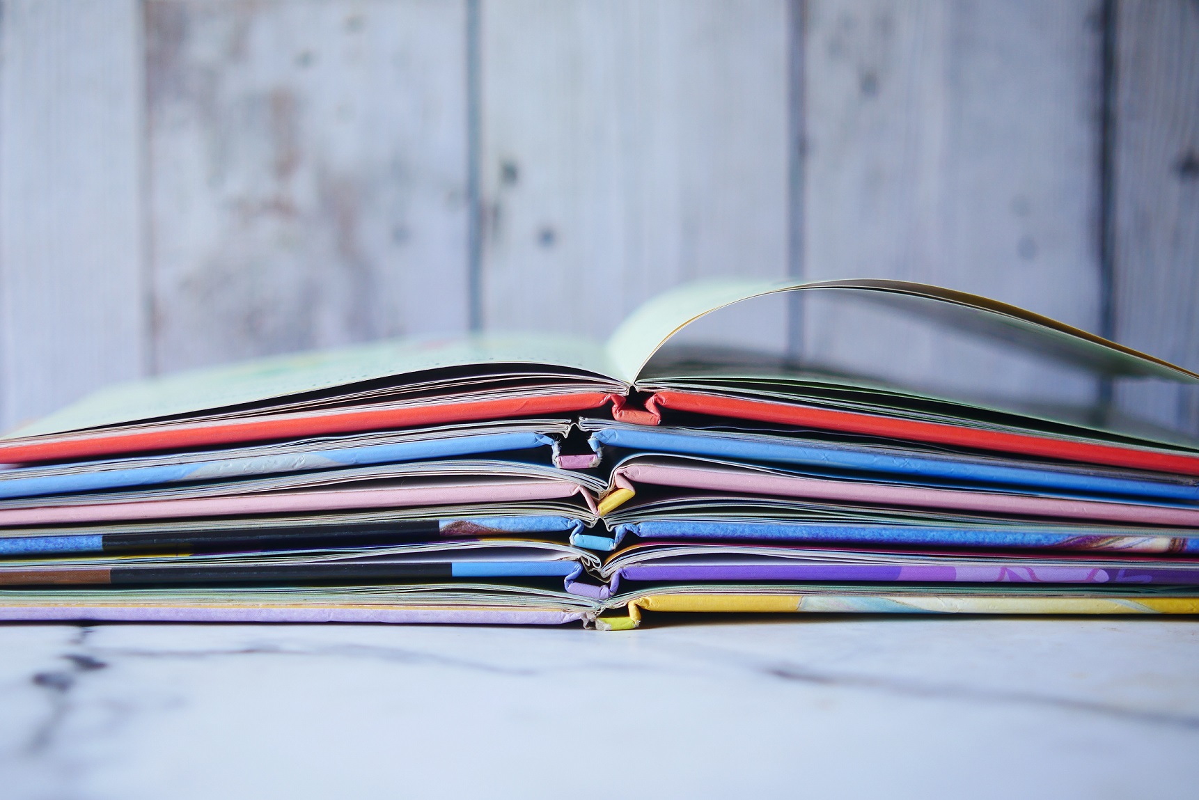 stack of color open book on table